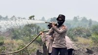 Puluhan Polisi Wanita (Polwan) Polda Riau berjibaku memadamkan titik api Karhutla di lahan gambut Pelalawan, menunjukkan komitmen dan dedikasi tinggi dalam penanganan bencana.