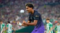 Pelatih Barcelona, Hansi Flick, memberikan instruksi kepada Lamine Yamal di pinggir lapangan.
